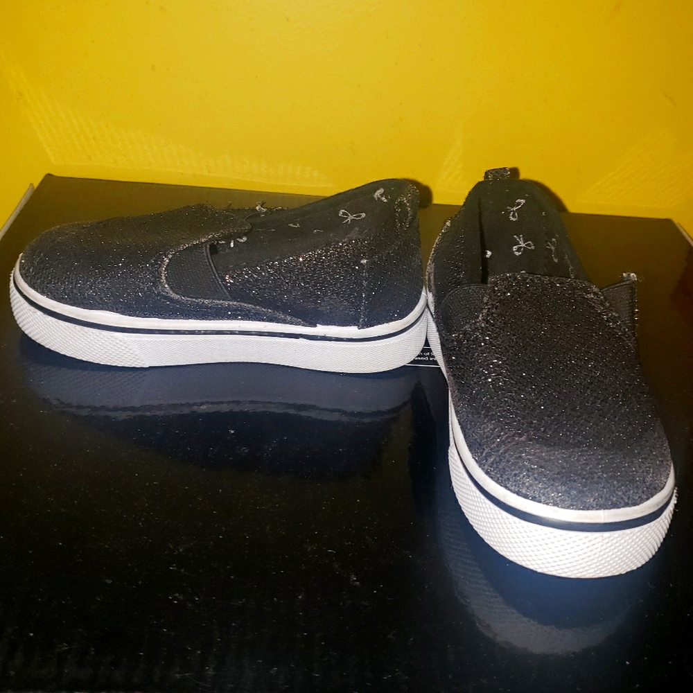 Black flat slip on shoes.